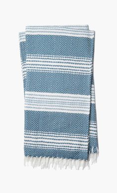 a blue and white striped towel with fringes