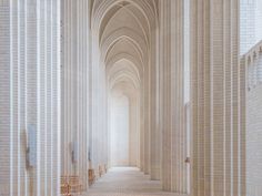 the interior of a cathedral with rows of wooden chairs lined up against the wall and floor