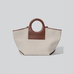 HEREU tote bag in canvas with leather trim. Ring top handles. Fabric lining. 15"H x 26"W x 9.8"D. "Cala" is made in Spain. Large Canvas, Canvas Tote Bag, Longchamp Le Pliage, Bergdorf Goodman, Leather Trim, Canvas Tote, Leather Trims, Tops Designs, Spain