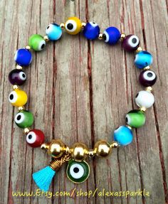 This beautifully handmade bracelet is made of round medium sized glass eye beads that are multicolors. They are made with elastic string and Adjustable Evil Eye Bracelet With 8mm Beads, Multicolor Beaded Evil Eye Bracelet Spiritual, Multicolor Beaded Evil Eye Bracelet, Multicolor Round Evil Eye Bracelets, Multicolor Evil Eye Round Bracelets, Spiritual Multicolor Round Stretch Bracelet, Adjustable Multicolor Evil Eye Beads, Multicolor Evil Eye Bracelets, Multicolor Evil Eye Bracelet Gift