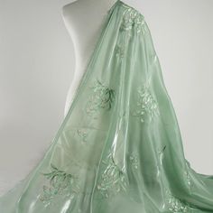 a light green dress with flowers on it