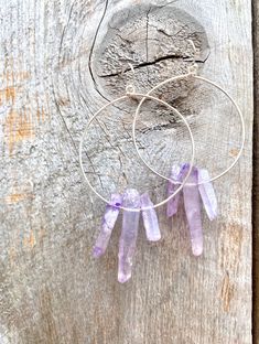 Raw purple quartz crystal points in gold or silver hoop earrings with French hooks. Perfect little boho look. Light weight and easy to wear. Add these to your boho outfits and make a 💜Healing clear quartz Crystal property has been know for centuries to restore balance in the body. -Options- 30mm as shown 21 gauge hoops Total drop Length: 2.3 inches 14k Gold filled hoops Sterling silver hoops Gold plated hoops Silver plated hoops All comes with hooks Simple, Dainty, Delicate, yet so Elegant and Bohemian Wire Wrapped Hoop Jewelry, Festival Hand Wrapped Dangle Jewelry, Festival Hand-wrapped Dangle Jewelry, Purple Bohemian Everyday Jewelry, Purple Dangle Hoop Earrings With Ear Wire, Nickel-free Purple Dangle Hoop Earrings, Purple Nickel-free Dangle Hoop Earrings, Handmade Bohemian Crystal Hoop Earrings, Bohemian Wire Wrapped Hoop Crystal Earrings