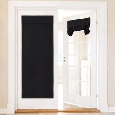 an open white door with black curtains on it