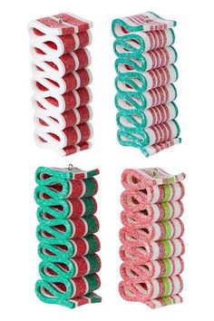 four different colors of hair clips on a white background