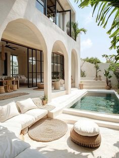 an outdoor living area with a pool and patio furniture