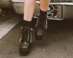 Normal is boring. Add some height to your day in these rad boots, featuring a cool, dino lug platform sole. Features a vegan friendly, black faux leather upper with a 7-eye lace-up closure. Has 4 removeable straps for some extra attitude. Has a sole height that is approximately 2 ¼” at the heel and 1 7/8” in the front. Has removable memory foam padding for added comfort. Casual Lace-up Platform Boots For Alternative Fashion, Streetwear Ankle-high Platform Boots With Metal Feet, Punk Style Platform Boots With Lug Sole For Streetwear, Ankle-high Platform Boots With Metal Feet For Streetwear, Trendy Platform Boots With Metal Feet For Streetwear, Trendy Streetwear Platform Boots With Metal Feet, Edgy Moto Boots With Chunky Platform For Streetwear, Trendy Ankle Platform Boots For Streetwear, Alternative Lug Sole Platform Boots For Concert