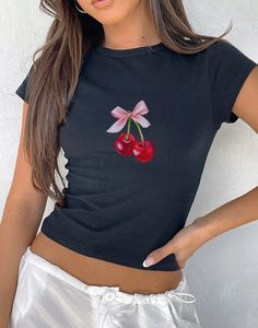 Introducing our Cherry Bow Art Baby Tee, a trendy blend of coquette aesthetic cherry-inspired style. Made from 100% premium cotton, this tee offers a luxuriously soft feel and a 90's/Y2K fit that ensures comfort all day long. Designed with a high-quality print, the Cherry Bow Baby Tee showcases a captivating bow motif and juicy cherries that adds a touch of girly elegance to any outfit. Our Baby Tee is crafted using the Gildan 5000b, a youth-sized shirt designed to authentically emulate the classic 90s/Y2K Baby Tee look. Whether paired casually with jeans or dressed up with a skirt, this tee seamlessly integrates into any wardrobe, making it an ideal choice for gifting. Embrace the allure of the coquette aesthetic with our thoughtfully crafted tee, where comfort meets fashion in every deta Sweet Fitted Tops For Spring, Sweet Fitted Tops For Summer, Fitted Cherry Print T-shirt For Summer, Fitted Short Sleeve T-shirt With Cherry Print, Fitted Cherry Print T-shirt With Short Sleeves, Fitted Short Sleeve Top With Cherry Print, Fitted Short Sleeve Cherry Print T-shirt, Fitted Cherry Print Short Sleeve T-shirt, Y2k Cherry Print Summer Tops