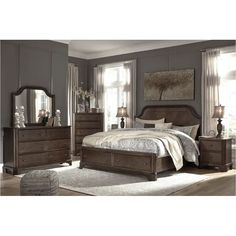 a bedroom scene with focus on the bed and dresser