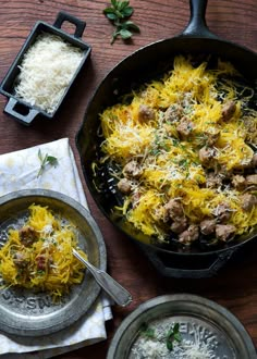 someone reaching for some food in a skillet