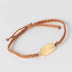 Live comfortably in your strength with this handcrafted macrame affirmation bracelet. Featuring the powerful message "You Are Strong," this adjustable piece is a daily reminder of your courage and perseverance. Handcrafted by women artisans at Nepal Knotcraft Centre, let this bracelet inspire you to face any challenge confidently. Materials: Brass, nylon - Measures: 10"L - Colors: Orange - Notes: Adjustable -Barcode: 732919545296 -Handcrafted in Nepal Adjustable Bohemian Bracelet For Good Luck, Orange Notes, Nepal Bracelets, Tibetan Bracelet Buddha Groove, Affirmation Bracelets, Mantra Bracelet, Buddha Bracelets, Colors Orange, Ten Thousand