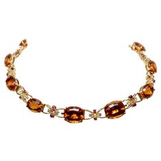 Semi-rigid choker necklace made in yellow gold with large oval-cut quartz (Citrines) alternating with intertwined links centered by two cabochon-cut rubies and two brilliant-cut diamonds. The necklace can be divided into two bracelets and a pendant. Approx. weight of stones: Quartz: 115,00 cts Diamonds: 1,60 cts, colour H, clarity VVS, Rubies: 4,00 cts 1950s Luxury Orange Necklace With Natural Stones, Luxury Vintage Antique Gold Necklace, Drink Outfit, Antique Necklace Gold, Orange Quartz, Hand Jewelry Rings, Quartz Choker, Choker Necklace Gold, Necklace Orange