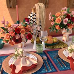 the table is set with plates, silverware, and vases filled with flowers