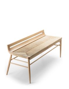 a wooden bench sitting on top of a white floor