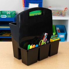 a black plastic storage container filled with school supplies