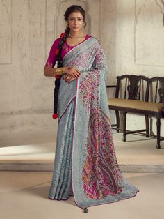 The saree features intricate brasso work on grey organza fabric, while the rani pink silk blouse is adorned with sequin and embroidery details. This 5.50-meter saree and unstitched blouse material are perfect for festivals, events, and any special occasion. Embrace the Bollywood glam with this beautifully designed saree that exudes elegance and grace. This saree set is a must-have in your ethnic collection. The grey color exudes sophistication, while the brasso work adds a touch of glamour. Brasso Saree, Grey Saree, Organza Silk Saree, Indian Blouse, Blue Saree, Organza Fabric, Organza Saree, Blouse Material, Fancy Sarees