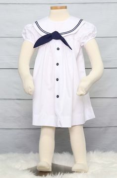 "She will look amazing in her nautical clothing for a nautical birthday in a sailor dress by Zuli Kids. Toddler sailor dress is shown in white with navy soutache trim on sailor collar. Also available in navy with white soutache trim. *Zuli Kids Premium Quality *Nautical Collar *Machine Wash Gentle *Button-Back Closures *Poly Cotton Fabirc *Puffed Sleeves *Short or Long Sleeves *Available in Sz 12 Mo - Sz 5 *Special Classic Garment to Commemorate the Special Day *Made in USA WHATS INCLUDED One sa Spring Sailor-style Short Sleeve Dresses, Sailor Style Short Sleeve Fitted Dress, Fitted Sailor Dress With Short Sleeves, Preppy Fitted White Dress, Summer Short Sleeve School Uniform Dress, Summer School Uniform Dress With Short Sleeves, White Sailor Dresses For Spring, White Sailor Cotton Dress, Sailor Style White Cotton Dress