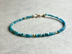 APATTE BRACELET WITH DELICATE GOLD DETAIL This pretty bracelet, made from Mini-Apatite-Beads has a length of 17.5cm.  If you like another length, please specify when ordering. (Bracelet in photo is 16cm long) I send all my jewelry packaged in a small jewelry pouch. MATERIAL Apatitw beads 2mm Vermeil beads 2mm Clasp-Gold filled Gold Gemstone Beads Friendship Bracelets For Gift, Gold Friendship Bracelets With Gemstone Beads As A Gift, Gold Friendship Bracelets With Gemstone Beads, Gold Bracelets With Gemstone Beads For Friendship, Gold Friendship Bracelets With Natural Stones As Gift, Yellow Gold Beaded Bracelet With Gemstones For Gift, Yellow Gold Beaded Bracelet With Gemstones As Gift, Yellow Gold Gemstone Beaded Bracelet Gift, Faceted Turquoise Beaded Bracelets For Gift