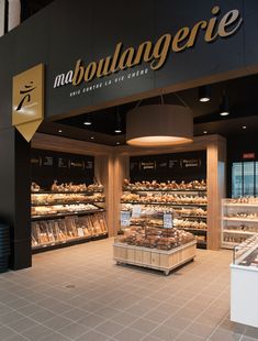 the interior of a bakery with bread and pastries