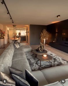 a living room filled with furniture and a large flat screen tv mounted to the wall