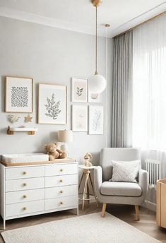 a baby's room with white furniture and pictures on the wall