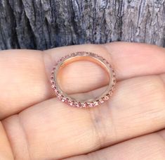 Full Eternity Band Ring with Natural Pink Sapphires. Material: Solid Gold (14K or 18K) Finishing: High Polished/ Shiny Fit: Standard Width: 1.8mm Height: 2mm Setting: U Micro Pave Set Stone: Natural Pink Sapphire Precious Stone Shape & Cut: Round, Diamond Cut Quality: AAA Quantity of Stones: apx 40 (varies by size) Total Carat Weight: 0.80 ct (varies by size) This Ring is Full of Elegance and Beauty! It is so Simple and so Complete at the same time! One can wear this band alone by itself or Pink Sapphire Round Band Wedding Jewelry, Pink Sapphire Round Cut Half Eternity Jewelry, Pink Sapphire Halo Jewelry With Round Cut, Pink Sapphire Eternity Band With Prong Setting For Anniversary, Pink Sapphire Round Eternity Band For Anniversary, Pink Sapphire Half Eternity Jewelry For Anniversary, Anniversary Pink Sapphire Eternity Band With Prong Setting, Rose Gold Ruby Ring With Halo, Anniversary Pink Sapphire Half Eternity Jewelry