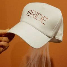 Brand New, Tags Attached White Baseball Hat With Attached Veil Bride Written In Pink Rhinestones Circumference Is 21.25", Stretches An Additional 1.5" For An Adjustable Fit. Veil Attached To Cap, 15" Length Bachelorette Party Or Bridal Shower Wedding Gift Great Gift From Bridesmaid Bridesmaid Color, White Baseball Hat, Hat With Veil, Bridesmaid Colors, New Bride, Bride Hat, Veil Wedding, Veil Brides, Wedding Bridesmaid