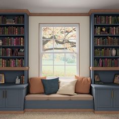 a living room with bookshelves, couch and window