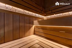 the inside of a wooden sauna with light shining on it's sides and floor