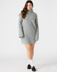 The ABBIE sweater dress is expertly crafted with a turtleneck and flare sleeves and offers a relaxed yet stylish fit. The soft brushed material provides warmth and comfort, making it the perfect mini dress for cooler weather. Elevate your wardrobe with this versatile and chic pullover dress. Mini sweater dress Turtleneck pullover style Flared long sleeves 98% polyester 2% elastane Hand wash Carla is 5ft 9in and is wearing a size large Lilia is 5ft 9in and is wearing a size small Imported Ribbed Turtleneck Mini Dress For Fall, Fall Ribbed Turtleneck Mini Dress, Cozy Mini Dress For Winter, Cozy Winter Mini Dress, Cozy High Neck Sweater Dress For Winter, Winter Mini Sweater Dress For Loungewear, Cozy High Neck Sweater Dress For Fall, Casual High Neck Mini Dress For Winter, Flared Sleeve Dress