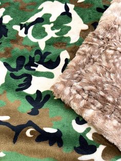 a close up of a blanket with camouflage print on it