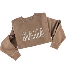 a brown sweatshirt with the word mama printed on it and white letters across the chest