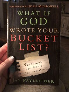 a person holding up a book with the title what if god wrote your bucket list?