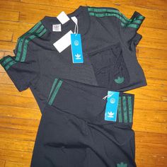 Black And Green Adidas Set. Adidas Fitted Cotton Activewear, Fitted Cotton Adidas Activewear, Green Athleisure Tops With Three Stripes Branding, Adidas Fitted Tops For Streetwear, Adidas Fitted Streetwear Tops, Fitted Adidas Tops For Streetwear, Black Three Stripes Workout Tops, Sporty Fitted T-shirt With Three Stripes Branding, Fitted Activewear For Streetwear With Three Stripes