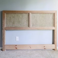 the headboard is made out of wood and has wicker paneling on it