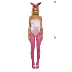 a woman wearing pink bunny ears and bodysuit