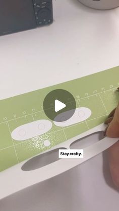 a person cutting out a piece of paper with scissors