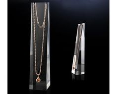 an award with a necklace on it and a glass display case in front of it