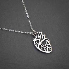 Give your heart to someone! This anatomically correct depiction of the heart is made from gold or silver colored non-tarnish steel and measures about 1" from top to bottom. The pendant hangs delicately from an 18" gold plated steel or sterling silver chain, but it is strong enough to last for years and years. Whether for yourself or someone special (your sweetheart, your mother, or your cardiologist), this pendant is sure to make an impression. Perfect for: Nurses, doctors & medical students Fri Nickel-free Heart-shaped Meaningful Jewelry, Stainless Steel Heart Necklace For Everyday, Hypoallergenic Heart-shaped Stainless Steel Jewelry, Everyday Heart Shaped Stainless Steel Necklace, Silver Surgical Steel Heart Jewelry, Silver Heart-shaped Surgical Steel Jewelry, Hypoallergenic Heart-shaped Metal Necklace, Hypoallergenic Heart Shaped Metal Necklace, Nickel Free Open Heart Stainless Steel Jewelry