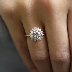 a woman's hand with a diamond ring on it