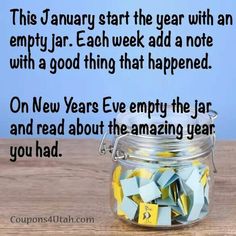 a glass jar filled with yellow and blue sticky notes on top of a wooden table