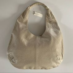 New. Anthropologie Pebble Leather Slouchy Shoulder Bag. Color: Cream Features: - 100% Sheep Leather - Magnetic Snap Closure - One Inside Zipper Pocket And Two Open Pocket - Polyester Lining - Measurements: 12”H X 19.5”W X 5.5”D - Handle Drop: 10 Inch Elegant Shoulder Bag With Pebbled Texture, Textured Leather Hobo Shoulder Bag For Errands, Neutral Leather Hobo Bag For Everyday, Everyday Neutral Leather Hobo Bag, Luxury Shoulder Bag With Pebbled Texture For Daily Use, Leather Shoulder Bag With Pebbled Texture And Top Handle, Leather Top Handle Shoulder Bag With Pebbled Texture, Luxury Top Handle Bag With Pebbled Texture, Neutral Leather Shoulder Bag For Everyday