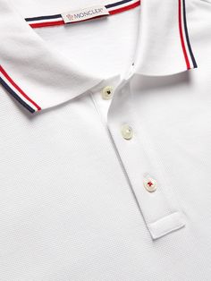 Even without the appliquéd logo on the chest, this polo shirt is recognisable as a Moncler design by the striped trims, which reference the French flag, and if you look closely you'll see the buttons are sewn on with threads in the same tricolour. This piece is made from cotton-piqué and cut in a comfortable, easy fit. Classic Striped Polo Shirt, Classic Striped Collared Polo Shirt, Classic Collared Polo Shirt With Signature Stripes, Classic Striped Polo Shirt With Collared Neckline, Classic Polo Shirt With Signature Stripes, Designer White Tops With Ribbed Collar, Striped Polo Shirt With Polo Collar For Golf, White Polo Shirt With Ribbed Collar For Work, Luxury White Polo Shirt With Ribbed Collar