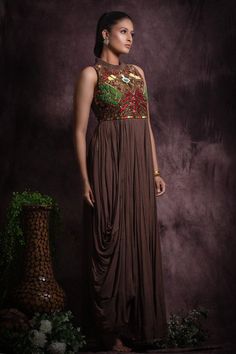 Brown in cut sleeves floor length flared gown embellished with multicolor sequin, bead work and thread embroidery on waist and cowl hem on one side.
Components: 1
Pattern: Embroidery
Type Of Work: Sequin, Beads
Neckline: Pleated collar
Sleeve Type: In cut sleeves
Fabric: Chinon, Lining: Cotton
Color: Brown
Other Details: 

Attached inner lining
Geometric and floral sequin embellishments
Length:
Gown(in inches): 59
Occasion: Cocktail, Reception - Aza Fashions Designer Wear Hand Embellished Maxi Gown, Designer Hand Embellished Maxi Gown, Designer Hand-embellished Maxi Gown, Hand Embellished Maxi Gown For Designer Wear, Multicolor Resham Embroidered Maxi Gown, Multicolor Maxi Gown With Resham Embroidery, Multicolor Floor-length Dress With Zari Work, Sequined Georgette Maxi Gown, Designer Maxi Gown With Sequins