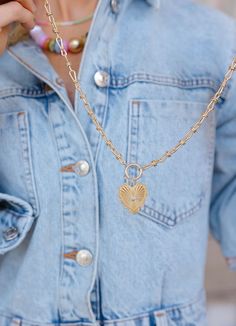 This gold toggle necklace with a heart charm is more than just a pretty piece—it's a daily reminder to love yourself and share that love with the world. The charm hangs on a beautifully unique chain, adding a trendy twist to your everyday look. Whether you’re dressing up or keeping it casual, this necklace is a stylish way to spread love and kindness wherever you go! Features • Gold plated brass • Measures 15.5” plus a 3” extender, 1.5” dropdown heart Everyday Heart Shaped Pendant Necklace With Charms, Heart Charm Pendant Necklace For Everyday, Everyday Heart Charm Pendant Necklace, Heart Pendant Locket Necklace With Adjustable Chain, Dainty Heart Charm Locket Necklace, Trendy Everyday Heart Pendant Necklace, Dainty Everyday Chain Necklace With Heart Charm, Trendy Gold-plated Heart Charm Necklace, Trendy Valentine's Day Charm Necklace