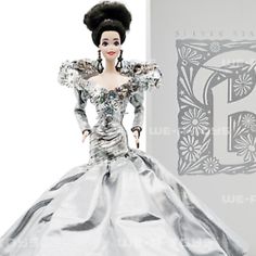 the doll is wearing a silver dress