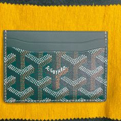 Brand New W/Tags - Goyard Saint-Sulpice Card Wallet - In Beautiful And Most Coveted Green. Harder And Harder To Get These Days. Goyard Is Limiting Their Colors And Sales Of Items. Beautiful Goyard Card Holder In Brilliant House Color Green. A Traditional Color And A Timeless Classic Piece. Goyardine Canvas And Calfskin Leather. This Is A Rare Beautiful Color! In Perfect/Mint Condition. Unworn, Unused. Negotiable. Offers Accepted. 4 Organizing Cards Slots And A Center Pocket. Very Compact, It Eas Designer Green Wallets With Interior Card Slots, Green Designer Wallets With Interior Card Slots, Designer Green Wallet With Interior Card Slots, Luxury Green Wallets With Card Slots, Luxury Green Wallets With Rfid Blocking, Luxury Green Wallets With Interior Card Slots, Green Luxury Wallets With Interior Card Slots, Luxury Green Wallet With Rfid Blocking, Luxury Green Wallet With Interior Card Slots