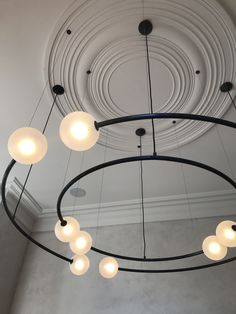 a circular chandelier hanging from the ceiling