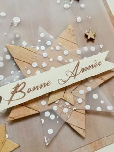 a close up of a greeting card with confetti and paper stars on it