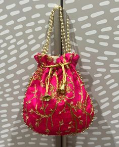 This is our beautiful Zardozi embroidered pouch. It comes with sequin threaded flowers.  This is perfect for storage at home or even for travel. This also makes for THE perfect gift!! DIMENSIONS:  8.5 inches length and 8 inches wide. Traditional Embellished Pouch Bag, Festive Embellished Pouch Shoulder Bag, Traditional Pink Shoulder Bag For Evening, Pink Bags For Evening And Festivals, Red Embroidered Potli Bag For Party, Pink Shoulder Bag With Handwork For Party, Festive Pink Potli Bag For Party, Pink Handwork Pouch Bag, Pink Zari Work Potli Bag For Party