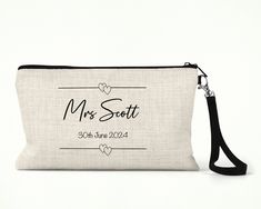 This Personalised Wedding Cosmetic Bag is a great gift idea for a bride to be. The make up bag is designed for a variety of purposes from storing pens and pencils, make up or essentials for a night out. The cosmetic bag is personalised with a name and date. The Personalised Wedding Cosmetic Bag is made from a thick polyester that is cream coloured, with a look and feel of linen canvas with removable black strap  The overall measurements are:  Width 24cm, Height 15cm. Rectangular Wedding Gift Pouch, Bridesmaid Gift Zipper Pouch Bag, Elegant Rectangular Bag For Personalized Gift, Elegant Rectangular Bags For Personalized Gifts, Rectangular Zipper Pouch Bag For Bridesmaid Gift, Wedding Pouch Bag With Zipper, Elegant Rectangular Bag As Personalized Gift, Rectangular Bridesmaid Gift Bag With Zipper Pouch, Wedding Zippered Pouch Bag